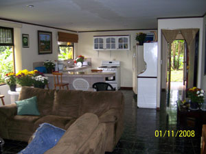 There is a roomy open-plan interior with kitchen, breakfast bar and living room.