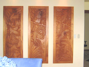 A display of bas relief wooden panels decorates one wall.