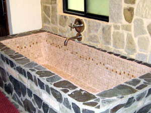 The master bathroom has a large custom-made ceramic tub in addition to double showers.