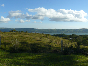 Section one, which has two small houses near the highway gate, rises to this terrific building site with lake and volcano views. 