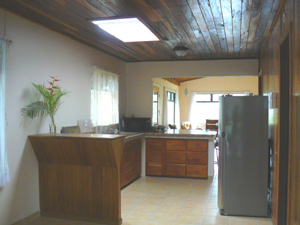 The kitchen is large, well-lit, and open to other rooms.