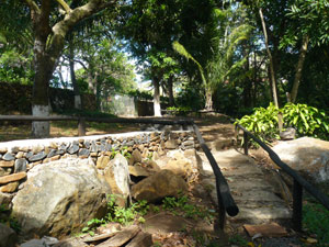 From the large gated parking area, a railed walkway leads down to the bridge.