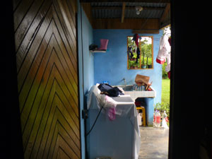 An outdoor covered laundry is accessed from the kitchen.