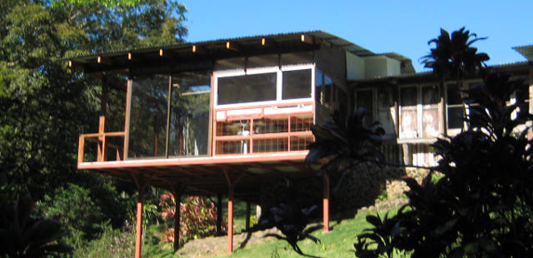 The large addition projects over a grassy slope to give even better views of the stream, forest, and sylvan landscaping. 