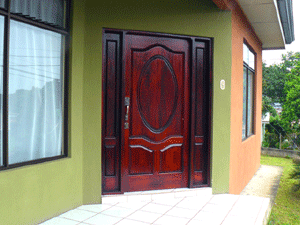 The front entrance has a handsomely deisgned wide wooden door.