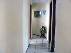 The raised hallway leads to the 3 bedrooms, 3 bathrooms, and laundry room.