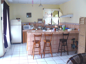 The kitchen, part of the open plan, has plenty of counter space and a convenient breakfast bar.