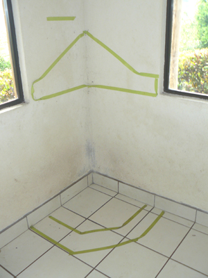 Tape outlines the location of the sculptor's plan for a fireplace. 