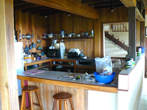 The kitchen is arranged so as to allow fine views of the near gardens, the intermediate forest, and the distant lowlands.