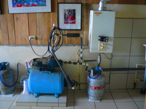 The house has stalwart infrastructural features such as this powerful water pump and in-demand hot water heater.