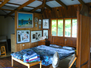 One of the two king-size beds sits in front of the second floor's bank of garden windows.