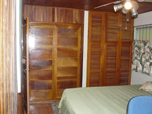 There's a wall of custom hardwood cabinetry in the master suite.