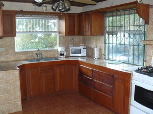 The kitchen is fully equipped and has beautiful custom hardwood cabinetry.