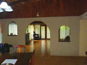 The liing room and dining room form a huge space partially separated by a pleasing wall.