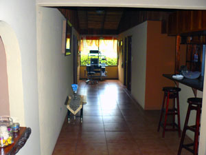 A broad hallway leads past the kitchen to the master suite and guest bathroom on the left and two bedrooms on the right.