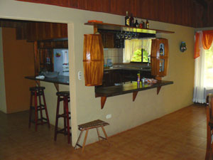 The kitchen has a broad passthrough to the dining room and breakfast counter.