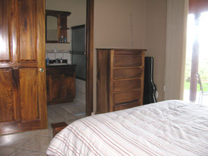 The master bedroom has a roomy bathroom, built-in hardwood closets and shelves and sliding glass doors.