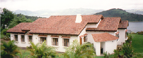 The large house has a fine landscaped lot and a great view of the lake.