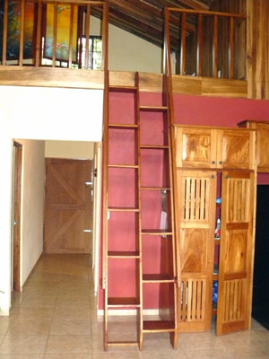 A stairway leads to the loft over the bedrooms and on the left the hallway leads to the master suite on the left and the second bedroom and guest bathroom on the right.