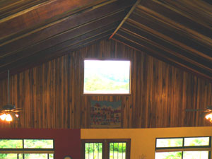 In this view from the loft the cathedral ceiling of fine hardwood shows off the spaciousness of the main area of the home.