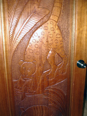 Interior doors are all of custom-made fine hardwood with bas-relief sculptures of Costa Rican wildlife.