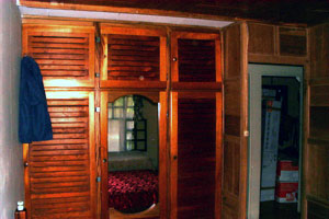 The interior of the home has much attractive woodwork as in these bedroom closets.