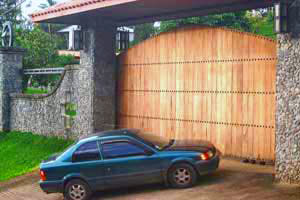 The property has a huge and handsome automatic wooden gate surrounded by stonework.