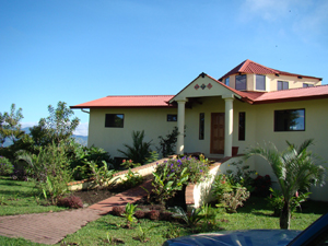 The home is entered from its large level grounds on the second or main level via a curving ramp to a handsome portico.