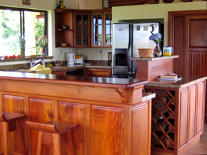 The kitchen has handsome custom hardwoods.