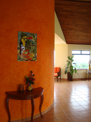 The This view of the curving stairway wall illustrates the rich colors, large spaces, and great views in the house.