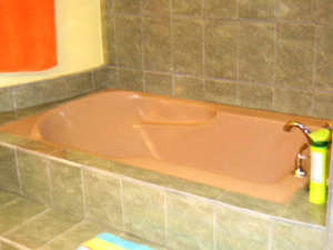 Handsome tile surrounds the master bathtub.