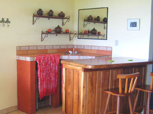 A wet bar fills a corner of a main room.