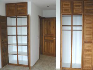 A hallway connects the bedroom and bathroom in the master suite.