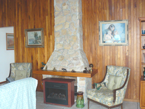 A stone fireplace is a handsome addition to the living room.