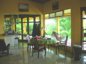 The expansive open interior includes this view of the living room, dining area, and kitchen.