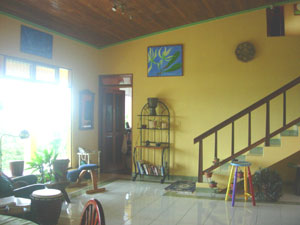 The high-ceilinged living room and open stairway to second floor.