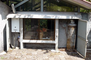 This compartment with propane tanks and a gas water heater supply cooking gas and hot water to the house and cottage. 