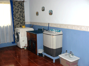 The washing machine and dryer occupy only a small part of the laundry.