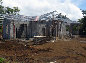 The front shows the master suite with patio on the left side, and the curving patio and window wall in front of the open kitchen/dining/living room.