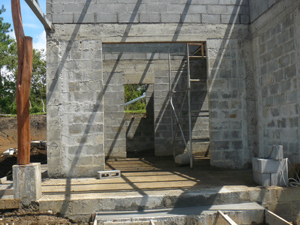 The master suite has a private roofed patio in front of the bedroom and large bathroom.