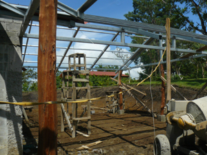 A port cochere large enough to shelter at least two cars leads to the entrance.