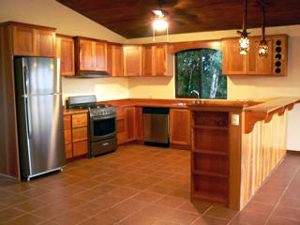 The large kitchen has stainless steel applinces and lots of custom hardwood cabinetry.