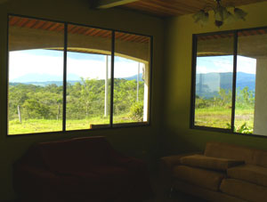 The living room has broad territorial views that include the dormant volcanos Tenorio and Mirravalles.