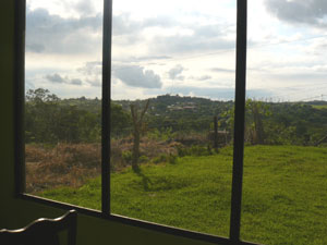 The master bedroom has huge windows which include a view of the village of Parceles on a neighboring hill.