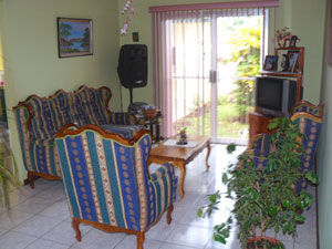 The TV room has a sliding door to the back garden. 