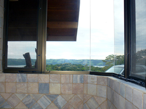 The master shower is finished in onyx and has windows with views on three sides.