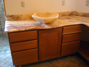 The master bathroom and the second bathroom have onyx countertops, floors and walls.