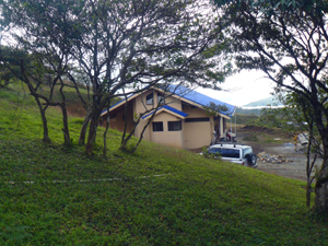 The house and lake as seen from the sloping orchard north of the house.