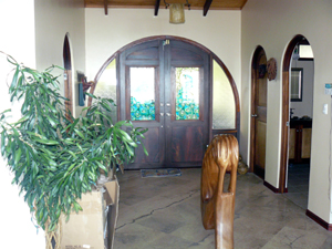 The arched entry has double doors with stained glass.