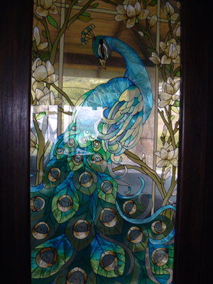 Each of the entrance doors has a peacock in stained glass.